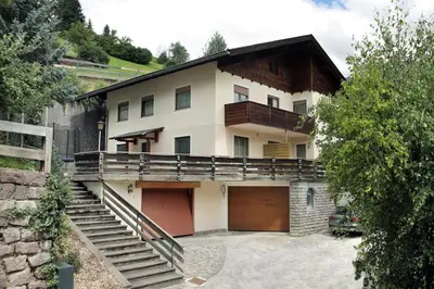 a large house with a garage and a staircase at Apartment Kristyn in Ortisei