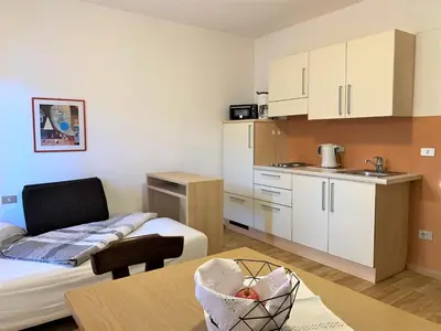 a small room with a kitchen and a table at Haus Sankt Peter in Lana