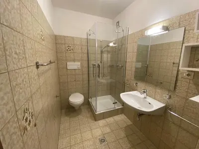 a bathroom with a shower and a toilet and a sink at Haus Sankt Peter in Lana
