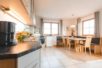 a kitchen with a table and a dining room at Obergruberhof in Chiusa