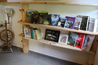 a shelf filled with books on a wall at Obergruberhof in Chiusa
