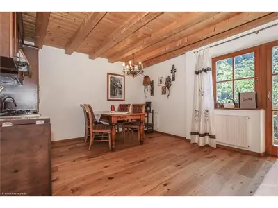 a kitchen and dining room with a table and chairs at Lexnhof in Montagna