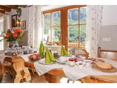 a dining room table with food on it with a window at Lexnhof in Montagna