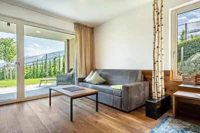 a living room with a couch and a table at Pataunerhof Tirol in Tirolo