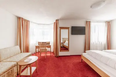a living room with a couch and a table at Hotel Oberwirt in Feldthurns