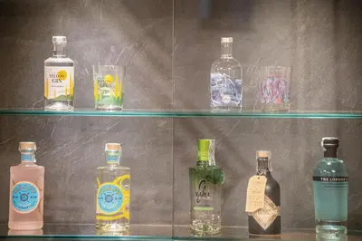 a row of bottles of alcohol on a shelf at Hotel Oberwirt in Feldthurns
