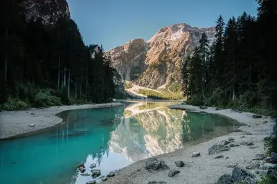 a river in the middle of a canyon with mountains at Dolomites Smart Holidays in Valdaora