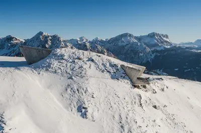 a snow covered mountain with mountains in the background at Dolomites Smart Holidays in Valdaora