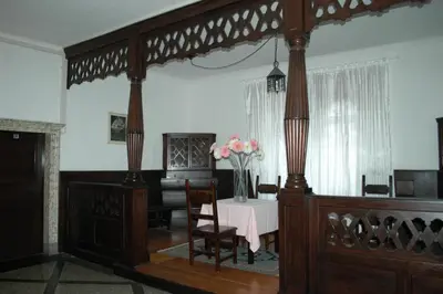 a dining room with a table with a vase of flowers at Albergo Casagrande in Laives
