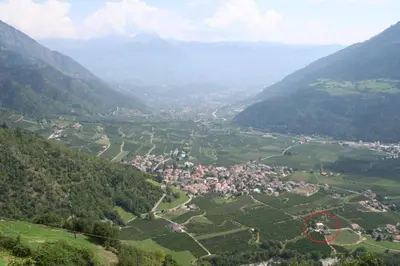 an aerial view of a village in the mountains at Mareinhof - Urlaub auf dem Apfelbauernhof in Parcines