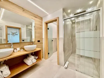 a bathroom with two sinks and a shower at B&B Family Accommodation Canazei SKI-IN SKI-OUT in Canazei