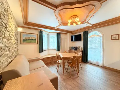 a living room with a couch and a table at B&B Family Accommodation Canazei SKI-IN SKI-OUT in Canazei