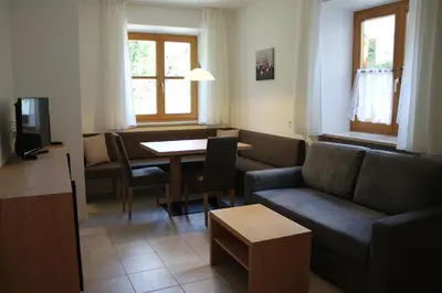 a living room with a couch and a table at Grieserhof Algund in Lagundo