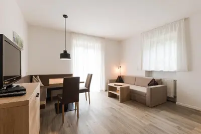 a living room with a couch and a table at Grieserhof Algund in Lagundo