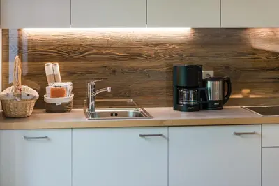 a kitchen counter with a sink and a coffee maker at Grieserhof Algund in Lagundo