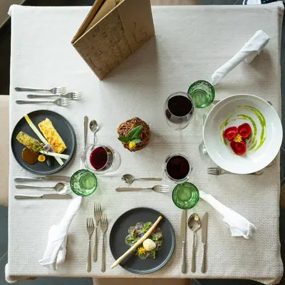 a table with plates of food and silverware on it at Hotel Untermelz in Plaus