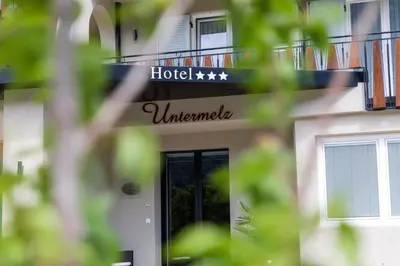 a hotel sign on the side of a building at Hotel Untermelz in Plaus