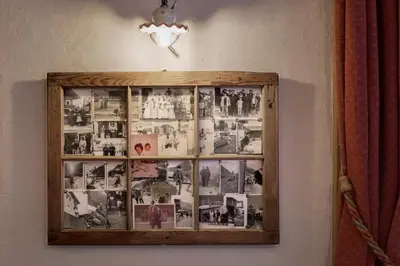 a picture frame on a wall with photos on it at Hotel & Ristorante Baita Dovich in Malga Ciapela