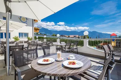 a table with two plates of food on a balcony at Das Mitterplarser Hotel in Lagundo