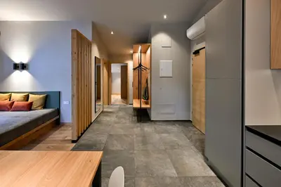 a small apartment with a bed and a hallway at Residence Winklgut in Lagundo