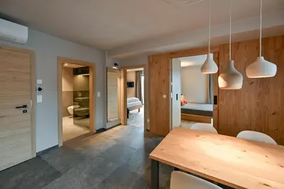 a kitchen and dining room with a table and chairs at Residence Winklgut in Lagundo
