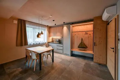 a kitchen with a table and chairs in a room at Residence Winklgut in Lagundo
