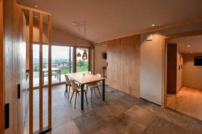 a dining room with a table and a large window at Residence Winklgut in Lagundo