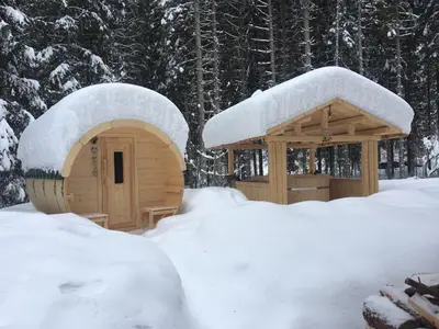 a sauna and a gazebo covered in snow at Hotel Garnì Il Cirmolo in Rocca Pietore