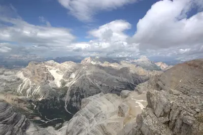 a view of a mountain range with clouds in the sky at Hotel Garnì Il Cirmolo in Rocca Pietore
