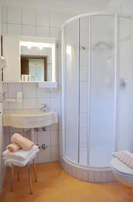a bathroom with a shower and a sink at Hotel Karin in Tirolo