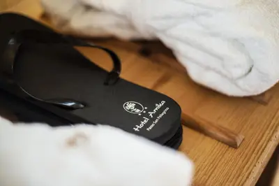 a black computer mouse sitting on top of a table at Hotel Arnika Wellness in Passo San Pellegrino