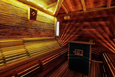 an inside of a wooden sauna with a trash can at Hotel Arnika Wellness in Passo San Pellegrino