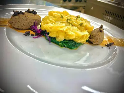 a plate of food on a white plate at Hotel Arnika Wellness in Passo San Pellegrino