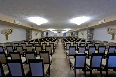 a room with rows of chairs in a classroom at Hotel Arnika Wellness in Passo San Pellegrino