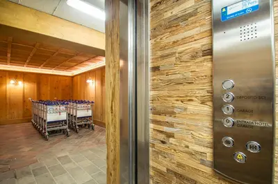 a door leading into a conference room with a table at Hotel Arnika Wellness in Passo San Pellegrino