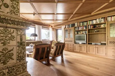 a living room with a table and chairs and a tv at Chalet Luis in Falzes