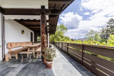 an outdoor patio with a wooden table and bench at Chalet Luis in Falzes