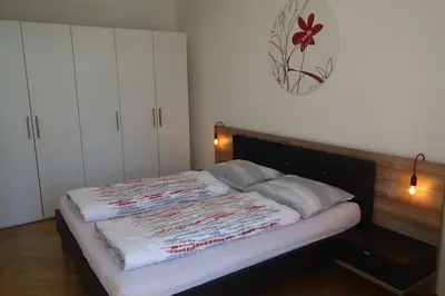 a large bed in a bedroom with at Hager Apartment in Merano