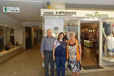 a group of people standing in front of a store at Hager Apartment in Merano