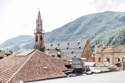 a view of a town with a church and roofs at Stay COOPER l Goethe Suite in Bolzano