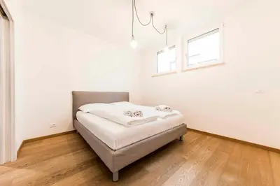 a bed in a room with a window at Stay COOPER l Goethe Suite in Bolzano
