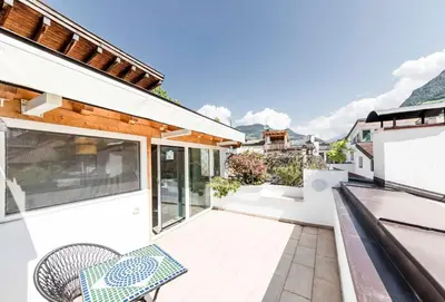 a balcony of a house with a chair at Stay COOPER l Goethe Suite in Bolzano