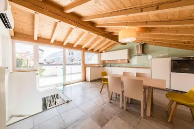 a kitchen with a table and chairs in a room at Stay COOPER l Goethe Suite in Bolzano