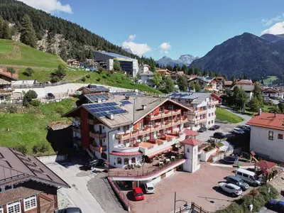 an aerial view of a hotel in a mountain town at Family Hotel Andes - Only for Family in Vigo di Fassa