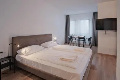 a bedroom with a bed and a table with chairs at Almarett in Racines