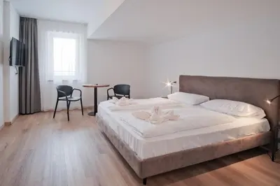a bedroom with a large bed and a table and chairs at Almarett in Racines
