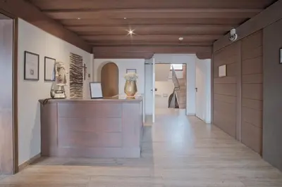 a hallway with a display of vases on a table at Almarett in Racines