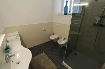 a bathroom with a toilet and a sink and a shower at Maria von Buol - Wohnen in Kaltern in Caldaro