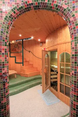 an archway in a building with a room with stairs at Hotel Trieste in Cortina dʼAmpezzo