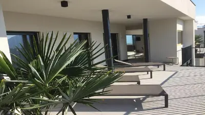 a row of chaise lounges on a patio at Penthouse Skygarden in Schenna